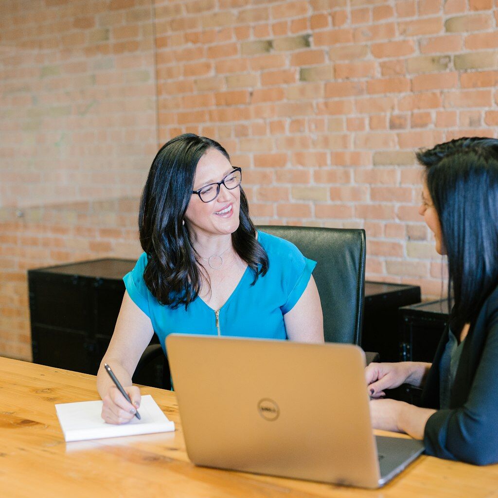 Novasoft analytics consultant collaborating with a customer over a Power BI dashboard