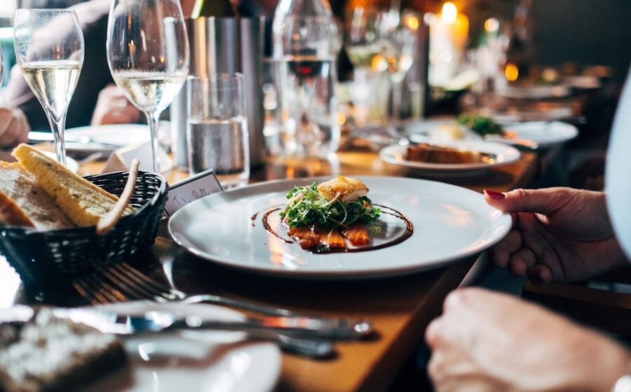 Upscale fine-dining restaurant table with plated dish and wine