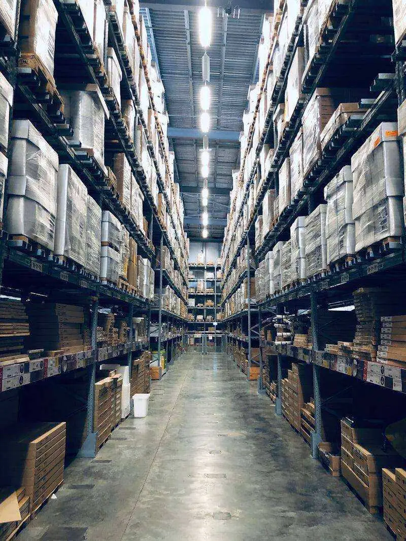 Wholesale and cash-and-carry — stacked pallets and warehouse operations powering